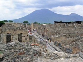 Pompeii ruins below Vesuvius. The eruption may not have vaporized victims, a new study finds. Rather, it baked and suffocated them.