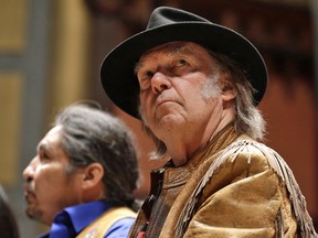Neil Young takes part in a news conference against the Athabasca tar sands on January 12, 2014, in Toronto.