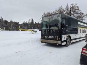 Quebec provincial police vehicles are seen in St-Henri-de-Taillon, Que. on Wednesday, January 22, 2020. One person is dead and five tourists from France are missing after a group of snowmobilers plunged through the ice Tuesday night near Quebec's Lac-Saint-Jean.