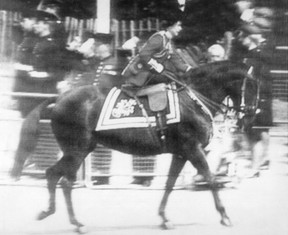 Queen Elizabeth II gives her horse ‘Burmese,’ a reassuring pat on the neck, after he reacted to six blanks fired by a man at the Trooping of the Colours ceremony at London in 1981.