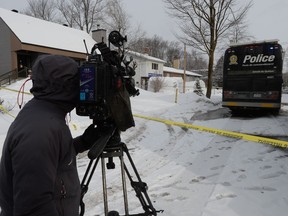 A camera operator films the scene outside a home in Mascouche, Que., Thursday, Jan.16, 2020. Quebec provincial police are investigating the killing of a woman in her 30s inside a home in Mascouche.