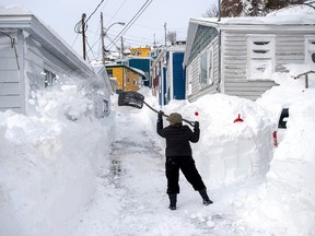 A resident clears snow in St. John’s on Sunday, Jan. 19, 2020. The state of emergency ordered by the City of St. John's continues, leaving most businesses closed and vehicles off the roads in the aftermath of the major winter storm that hit the Newfoundland and Labrador capital.
