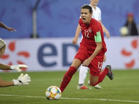 Canada's Christine Sinclair, right, tries a shot during the Women's World Cup Group E soccer match between Canada and New Zealand in Grenoble, France, Saturday, June 15, 2019.
