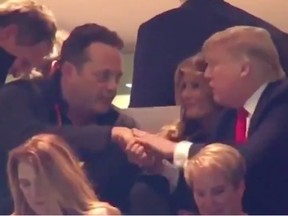A screenshot showing actor Vince Vaughn and U.S. President Donald Trump shaking hands at a football championship game.