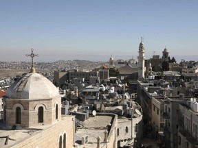 A general view of the West Bank biblical city of Bethlehem on December 19, 2019 with the minaret of a mosque and the Church of the Nativity (top R), the site where Christians believe Jesus was born.