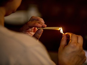 A customer lights a joint at the Lowell Cafe, a new cannabis lounge in West Hollywood, Calif., on Oct. 1, 2019.
