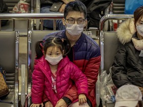 Chinese nationals, whose flight was cancelled after the Philippine government imposed travel restrictions to and from China amid the outbreak of the Wuhan Coronavirus, rest at the departure hall of the Ninoy Aquino International Airport on Feb. 3, 2020 in Manila, Philippines.