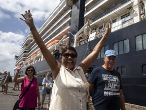 Excited passengers disembark from the MS Westerdam cruise ship after being stranded for two weeks, now docked on Feb. 14, 2020 in Sihanoukville, Cambodia.