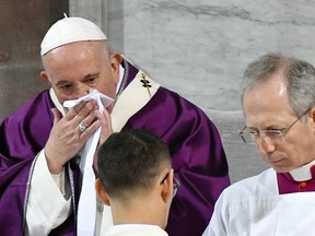 Pope Francis wipes his nose during the Ash Wednesday mass which opens Lent, the forty-day period of abstinence and deprivation for Christians before Holy Week and Easter, on February 26, 2020, at the Santa Sabina church in Rome.