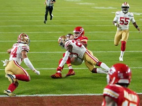 Kansas City Chiefs quarterback Patrick Mahomes (15) is tackled by San Francisco 49ers free safety Jimmie Ward (20) during the first quarter in Super Bowl LIV at Hard Rock Stadium.