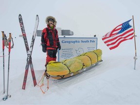 In this photo released by Colin O'Brady on December 14, 2018, shows adventurer Colin O'Brady posing for a photo at the Geographic South Pole sign in Antarctica.