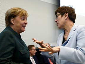 German Chancellor Angela Merkel speaks with Germany's Defense Minister Annegret Kramp-Karrenbauer during the meeting of the Christian Democratic Union's Bundestag fraction in Berlin, Germany February 11, 2020.