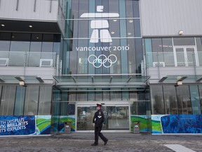 A police officer walks past the athletes village entrance in downtown Vancouver, Tuesday, Feb. 2, 2010.