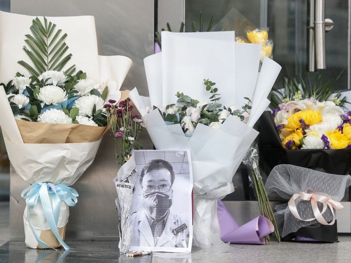  A photo of the late ophthalmologist Li Wenliang is seen with flower bouquets at the Houhu Branch of Wuhan Central Hospital in Wuhan in China’s central Hubei province on Feb. 7, 2020.