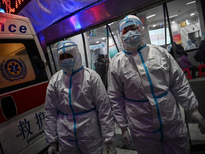  This file photo taken on January 25, 2020 shows medical staff members wearing protective clothing, walking at the Wuhan Red Cross Hospital in Wuhan.