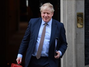 Britain's Prime Minister Boris Johnson leaves from 10 Downing Street in London on February 11, 2020, before heading to the House of Commons where he is expected to make a statement. - British Prime Minister Boris Johnson was set Tuesday to announce his plans for the HS2 high-speed railway, with reports suggesting he will stick with the long-running project despite soaring costs.