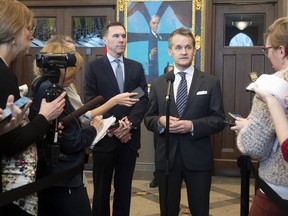 Minister of Finance Bill Morneau looks on as Natural Resources Minister Seamus O'Regan responds to a question from the media in Ottawa, Tuesday, February 4, 2020.