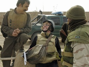 Christie Blatchford shares a lighter moment on Nov. 21, 2007, with local soldiers during one of her tours of Afghanistan.