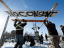 Counter protesters tear down a blockade along the CN rail line in Edmonton, Feb. 19, 2020.