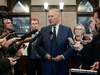Public Safety Minister Bill Blair, flanked by Indigenous Services Minister Marc Miller and Crown-Indigenous Relations Minister Carolyn Bennett, talks to reporters on Parliament Hill, Feb. 20, 2020.