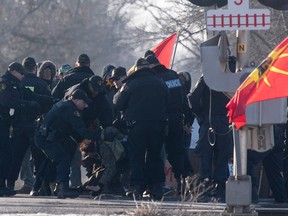 Ontario Provincial Police officers make arrests at a rail blockade in Tyendinaga Mohawk Territory, near Belleville, Ont., on Feb. 24, 2020.