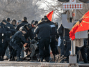 Ontario Provincial Police officers make arrests at a rail blockade in Tyendinaga Mohawk Territory, near Belleville, Ont., on Feb. 24, 2020.