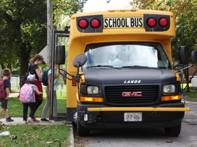 Students board the bus after class at London Road school in Sarnia.