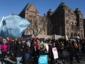 Protesters join a demonstration organized by the Teacher's Unions outside the Ontario Legislature, in Toronto, as four Teacher's Unions hold a province wide education strike, on Friday, February 21, 2020.