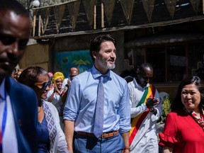 Canada's Prime Minister Justin Trudeau, center, is accompanied by Samrawit Moges, center-left, Founder and Co-Director of Travel Ethiopia, and Mary Ng, right, Canada's Minister of Small Business, Export Promotion and International Trade, as they arrive at the Yod Abyssinia traditional restaurant for a meeting with Ethiopian women entrepreneurs, in Addis Ababa, Ethiopia Sunday, Feb. 9, 2020.