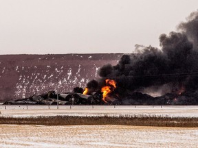 Federal Transportation Minister Marc Garneau is easing speed restrictions placed on certain trains following a derailment in Saskatchewan earlier this month that spilled 1.2 million litres of crude oil and started a massive fire. Smoke billows up from a derailed Canadian Pacific Railway train near Guernsey, Sask., on February 6, 2020.