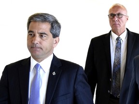 Conservative MPs Pierre Paul-Hus, left, and Glen Motz arrive for a meeting of the Standing Committee on Public Safety and National Security in Ottawa on Monday, July 15, 2019. The Conservatives want to know what federal officials are doing about China's alleged involvement in the theft of data from thousands of Canadians.THE CANADIAN PRESS/Justin Tang
