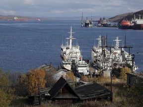 Ships dock at the piers at the seaport town of Murmansk on the Kola peninsula in Russia, Sunday, Sept. 22, 2013. The international body that regulates shipping is moving to ban a highly polluting type of fuel from the Arctic.