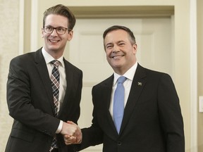 Alberta is looking at making new rules to stop sex offenders from being legally allowed to change their names. Alberta premier Jason Kenney shakes hands with Nate Glubish, Minister of Service Alberta after being sworn into office, in Edmonton, Tuesday, April 30, 2019.