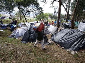 Venezuelan migrants camp in a park near the main bus terminal in Bogota, Colombia, Friday, Sept. 7, 2018. Colombia's ambassador to Canada says Venezuela's 1.4 million refugees will always be welcome in his country but his true hope is that they are able to one day return their own free and democratic homeland.