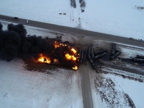 Fire and smoke rise from the site where a train derailed near Guernsey, Sask., in a Feb. 6, 2020, handout image.