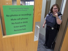 A sheriff stands at the door at the Desmond Fatality Inquiry in Guysborough, N.S. on November 18, 2019. The inquiry investigating why an Afghanistan war veteran killed his family and himself in 2017 has turned its attention to how the mentally ill former infantryman was able to legally purchase a firearm.