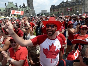 People cheer during Canada Day celebrations on Parliament Hill in Ottawa on Sunday, July 1, 2018. Canada's biggest annual birthday bash is being shifted away from Parliament Hill.