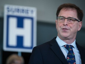 A hospice society in British Columbia says it is outraged by the province's decision to stop its funding because it refuses to provide medically assisted death. British Columbia Health Minister Adrian Dix speaks before Premier John Horgan announces a new hospital would be built in Surrey, B.C., Monday, Dec. 9, 2019.