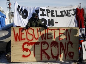 Supporters of the Wet'suwet'en hereditary chiefs block a CN Rail line just west of Edmonton Alta, on Wednesday February 19, 2020.