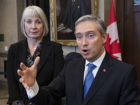 Foreign Affairs Minister Francois-Philippe Champagne and Minister of Health Patty Hajdu speak with the media in the Foyer of the House of Commons in Ottawa, Wednesday, February 5, 2020.