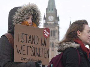 Protesters in solidarity with the Wet'suwet'en hereditary chiefs opposed to the LNG pipeline in northern British Columbia block an Ottawa intersection Wednesday, Feb. 12, 2020. Via Rail has extended train cancellations on major routes in Ontario and Quebec as protests against a pipeline in northern B.C. stretched into a sixth-day on Wednesday