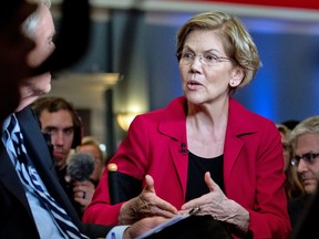 Senator Elizabeth Warren, a Democrat from Massachusetts and 2020 presidential candidate, speaks to a member of the media following the Democratic presidential candidate debate in Charleston, South Carolina, U.S., on Tuesday, Feb. 25, 2020.