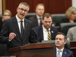 Finance Minister Travis Toews, left, delivers the budget as Alberta Premier Jason Kenney watches in Edmonton on Thursday February 27, 2020.