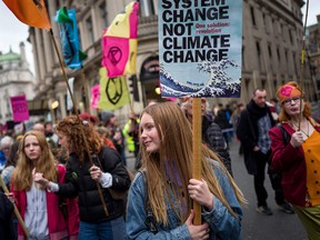 Climate activists march in a protest organized by Extinction Rebellion, in London, England, on Feb. 22, 2020.