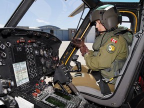 Capt. Stef Pouliot prepares to co-piloting a flight in a CH-146 Griffon helicopter at Canadian Forces Base Trenton, Ont., June 16, 2016.