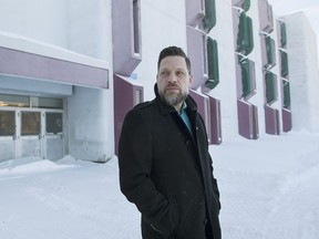 Jacques Langlois poses outside Louis-Joseph-Papineau school in Montreal, Saturday, February 8, 2020. Langlois started a petition to have windows installed in the school.