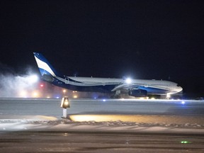 A plane carrying 176 Canadian citizens from the centre of the global novel coronavirus outbreak in Wuhan, China, lands at CFB Trenton, in Trenton, Ont., on Friday, Feb. 7, 2020.