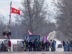Supporters stand with protesters during a rail blockade in Tyendinaga Mohawk Territory, Ont. on Monday, Feb.17, 2020, in solidarity with the Wet'suwet'en hereditary chiefs opposed to the LNG pipeline in northern British Columbia.