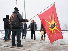 OPP Sgt. Diana Hampson of the liaison team, middle, speaks with members of the Mohawk Territory in Tyendinaga Mohawk Territory, near Belleville, Ont., on Tuesday, Feb. 11, 2020. The members have blocked the CN/VIA train tracks for six days in support of Wet'suwet'en's blockade of natural gas pipeline in northern B.C.