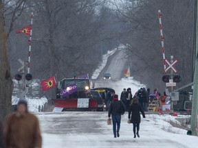People arrive at the train track blockade in Tyendinaga Mohawk Territory near Belleville, Ontario, on Tuesday Feb. 11, 2020, in support of Wet'suwet'en's blockade of a natural gas pipeline in northern B.C.